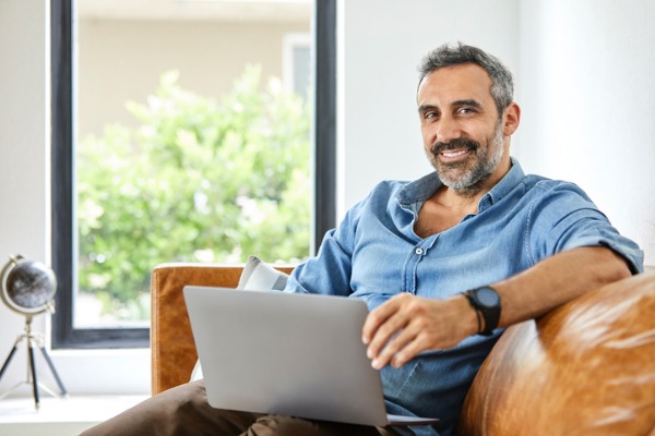 Man sitting at home with laptop